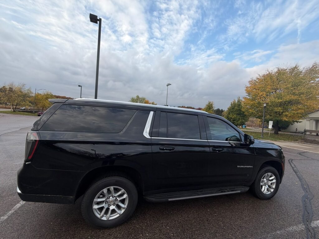 Side view of a black Chevrolet Suburban black car service vehicle in Minneapolis